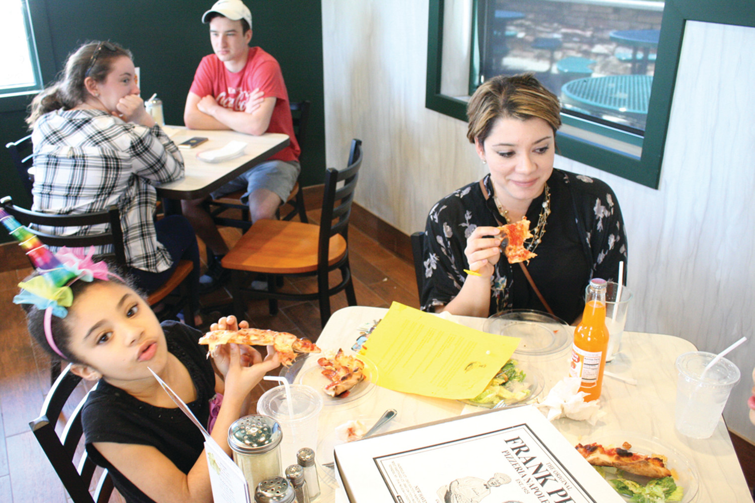 PIZZA OVER SCHOOL: Jennifer Valley brought her daughter, Lyric De Jesus, and son, Jonathan De Jesus, to the free pizza day Friday afternoon at Frank Pepe’s, saying it was tough to pass up the tasty deal. The family lives in Warwick.